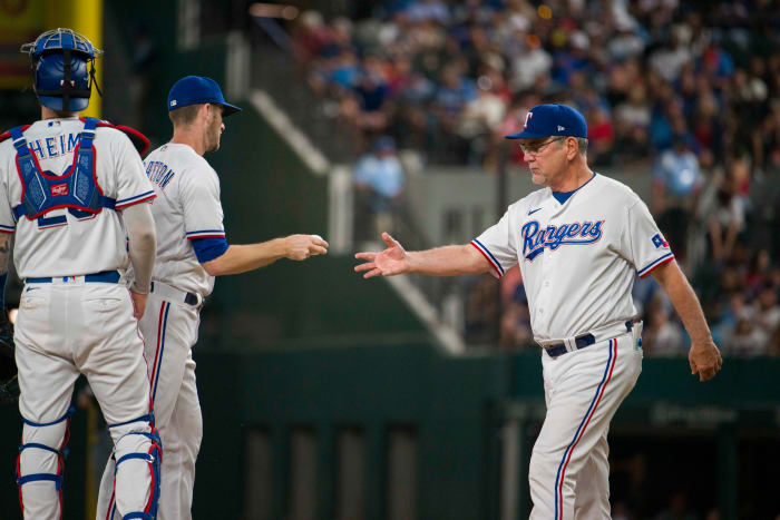 Sep 6, 2023; Arlington, Texas, USA; Texas Rangers manager Bruce Bochy (15) takes the ball from Texas Rangers relief pitcher Chris Stratton (35) during the game against the Houston Astros at Globe Life Field. Mandatory Credit: Jerome Miron-USA TODAY Sports
